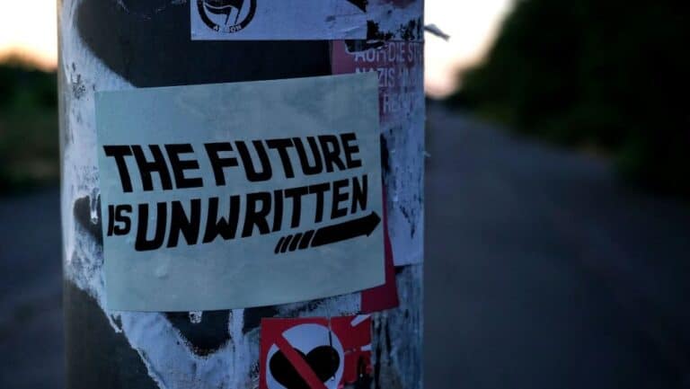 Sign posted on pole that reads: 'The future is unwritten'.